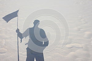 The shadow of the Wanderer hold the flag on the desert
