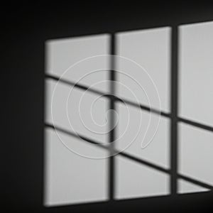 Shadow of a window with a grid pattern cast on a plain, light-colored wall. The