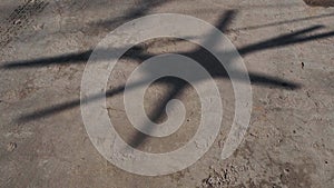 Shadow of a yacht`s rotating wind turbine at a marina