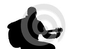 Shadow of young musician tuning up guitar, professional writing song, hobby