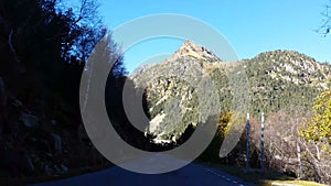 Shadowed Sinuous Road in Pyrenees Mountains-Vehicle Point of View