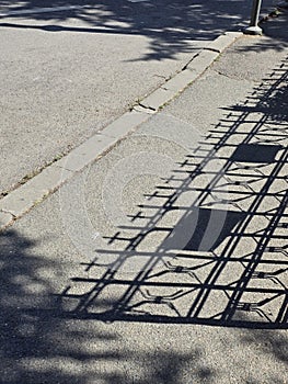 Shadows of a church fence with crosses