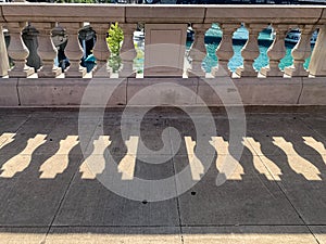 Shadows of concrete railing separating upper Chicago Loop with the Chicago River photo