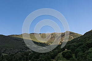 Shadows covering green mountains & forests