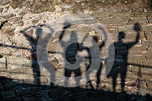 Shadows from four people on the wall