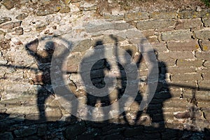 Shadows from four people on the wall