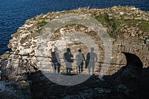 Shadows from four people on the wall