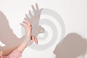 Shadows from the hand on white wall