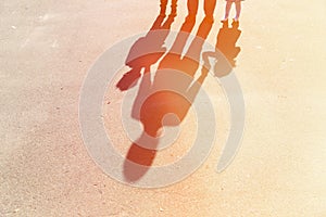 Shadows of mother with son and daughter holding