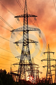 Shadows ofEnergy transmission towers. High voltage tower silhouette sunset.