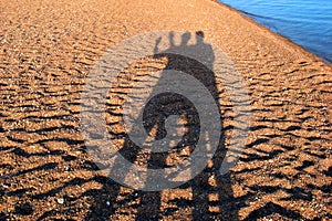 Shadows people on the beach photo