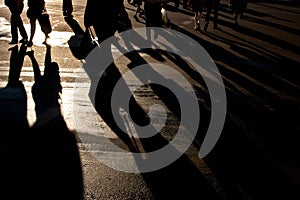 Shadows of people walking street