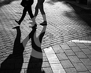 Shadows of people walking street