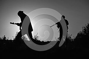 Shadows of soldiers with weapons at night