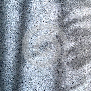 Shadows on a textured embossed wall. Abstract minimalistic background.