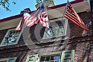 Shadows on three flags under a window on Old City Philadelphia