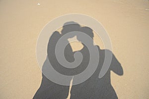 Shadows two people on beach