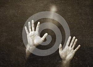 Shadowy figure behind scratched glass