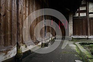 Shady path before ancient wood structural dwelling building