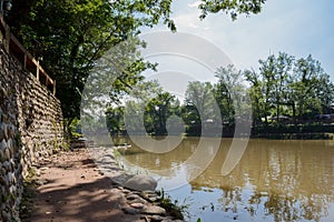 Shady riverside path in sunny autumn