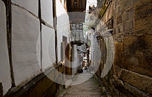 Shady stone stairway between ancient houses in small town