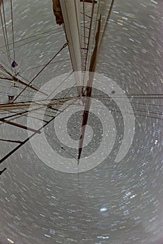 Shaft of a moving sail boat against starry sky