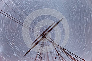 Shaft of a moving sail boat against stars in the sky