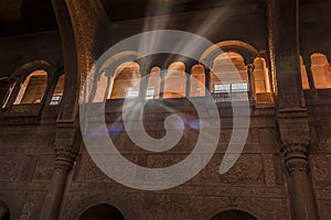 Shafts of light shatter the gloom in a vaulted hall in a fort in Rajasthan, India