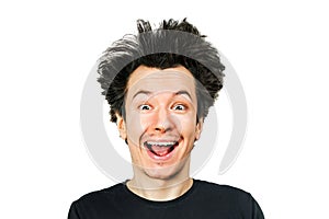 Shaggy mad young man freak with long hair, smiling on white isolated background