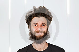 Shaggy young bearded man with long hair before haircut