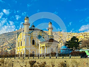 Shah Du Shamshira Jamia Mosque with a cloudy blue sky in the background, in Kabul, Afghanistan