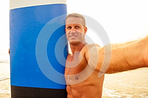 Shaka hand gesture surfers symbol.shirtless surfer man surfboard beach summer sunset sea.surfing man photographing on a