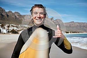 Shaka hand sign, beach and surfer with surfboard for fitness, fun and adventure on vacation. Sports, travel and portrait