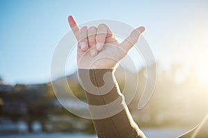 Shaka, hand sign and surfer outdoor in nature on an adventure or holiday in summer in hawaii. Chill out gesture