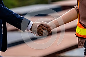 Shake Hand of Business man with Worker in Reflective Vest