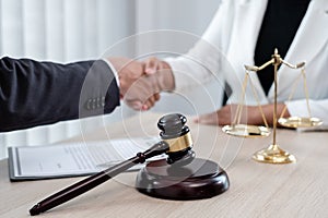 Shake hand Professional male lawyers work at a law office There are scales, Scales of justice, judges gavel, and litigation