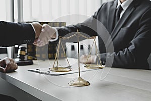 Shake hand Professional man lawyers work at a law office There are scales, Scales of justice, judges gavel, and litigation