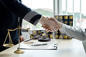 Shake hand Professional man lawyers work at a law office There are scales, Scales of justice, judges gavel, and litigation