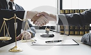 Shake hand Professional man lawyers work at a law office There are scales, Scales of justice, judges gavel, and litigation