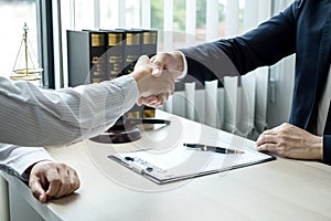 Shake hand Professional man lawyers work at a law office There are scales, Scales of justice, judges gavel, and litigation