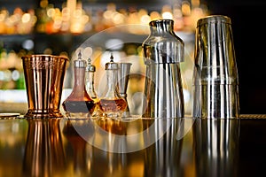 Shakers and copper glass and angostura bitters on counter of the bar