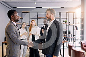 Shaking hands of african and caucasian people