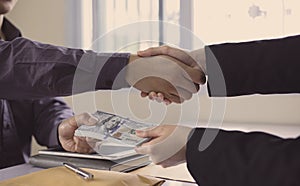 Shaking hands with congratulations on an evil plan