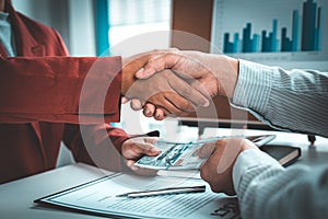 Shaking hands with congratulations on an evil plan