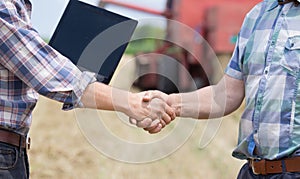 Shaking hands on farmland