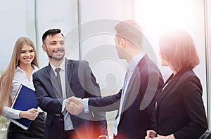 Shaking hands in the office at the beginning of the working day