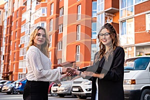 Shaking hands between sales agent and buyer