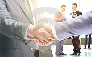 Shaking hands to confirm their partnership