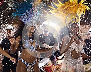 Shaking to the Brazilian beats. Shot of samba dancers performing in a carnival.