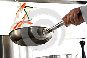 Shaking vegetables on a fring-pan photo